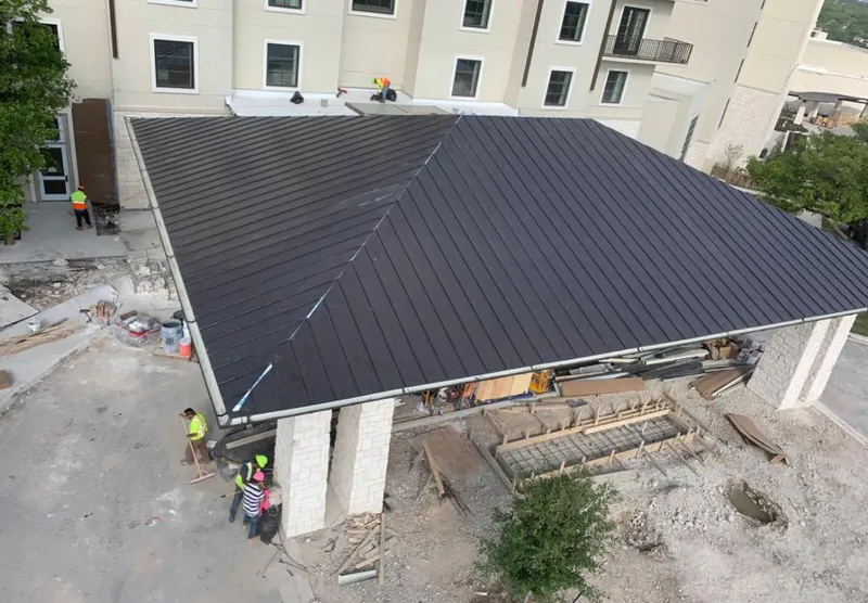 Metal roofing installation team working on a commercial building in Duncanville