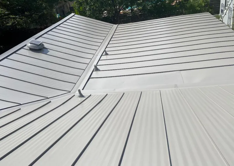 Solar attic fan installed on a metal roof for Roof Ventilation in Duncanville